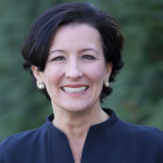 Portrait of a woman with short dark hair smiling at the camera.